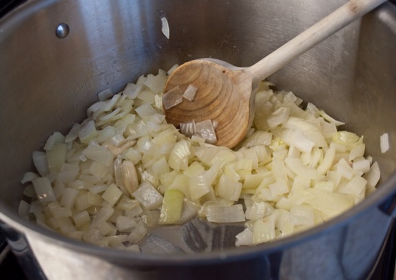 Begin by cooking the onions and garlic in butter until soft.