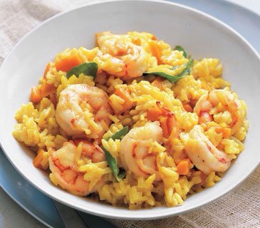 Season the shrimp with ½ teaspoon salt and ¼ teaspoon pepper. Nestle them in the partially cooked rice. Cover and cook until the shrimp are opaque throughout, 4 to 5 minutes. Fold in the basil.