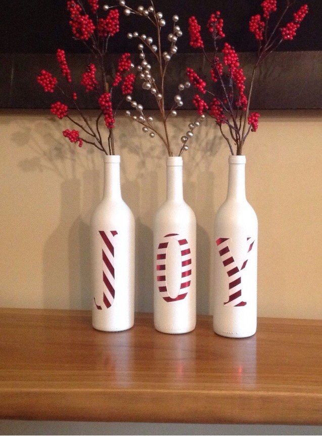 Get white bottles, write the word on them using stickers, place flowers inside.