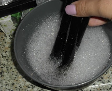 2. Fill a bowl with lukewarm water and a squirt of shampoo, and gently swirl your brush tip in the water. If you need to, you can also swirl the brush in the palm of your hand to work up a lather.

