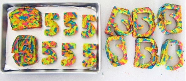 Cut out whatever you want to be shown in the middle of the cake, a number or even a letter or shape would work