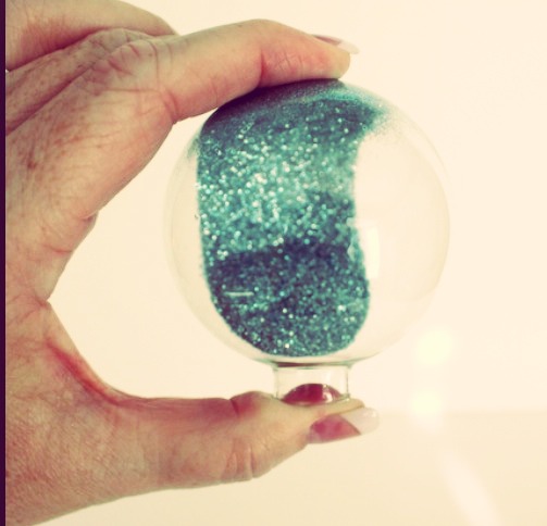 Step three- tilt the ornament around until the entire inside is coated in sparkles, then let dry.