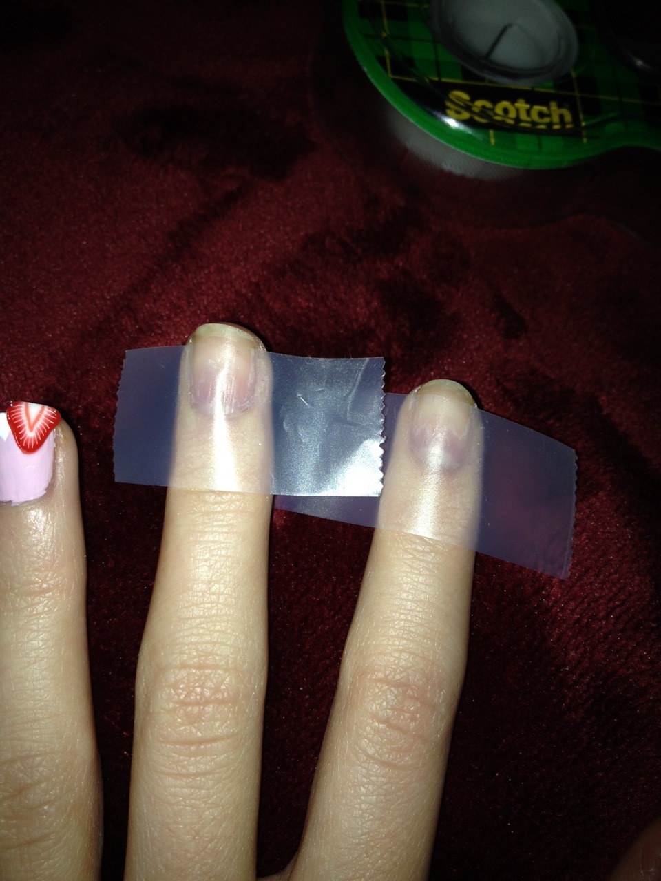 Step 9
Now take your take and put it across your nails so that there is a little space above it. Make sure that the tape is stuck all the way down on your nail so it stays