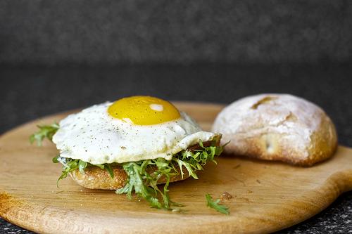 Remove the egg from the pan and place it on top of the bacon-frisée salad on the bun. Repeat with remaining egg and come on, what are you waiting for? Dig in.
