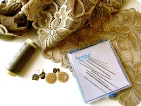 Here's what you'll need:
Lace
Scissors (not shown here)
Thread and needle or sewing machine
Other decorative items like buttons (optional)