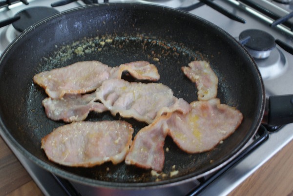 Then, you fry up some bacon (not 100% crispy and done, as it will go in the oven and finish baking).
