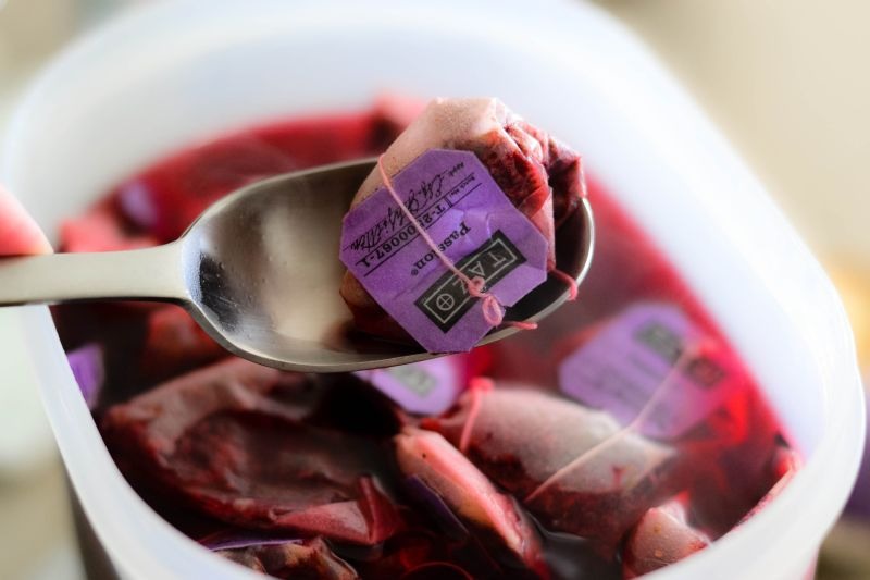 Once it's finished steeping, use a spoon to scoop out one bag at a time.