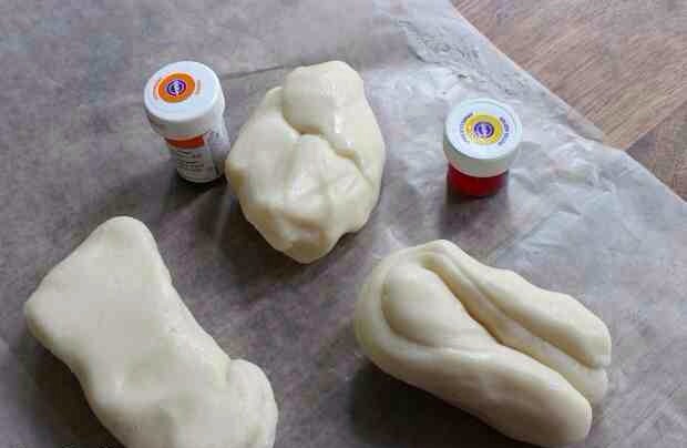 Divide the mixture into thirds and color two of pieces with yellow and orange, kneading until well combined.
