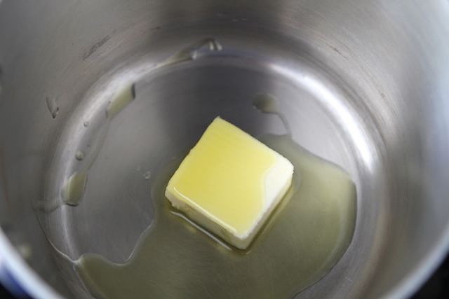 First, make the garlic cream sauce. Melt the butter, along with the olive oil, on medium to low heat.