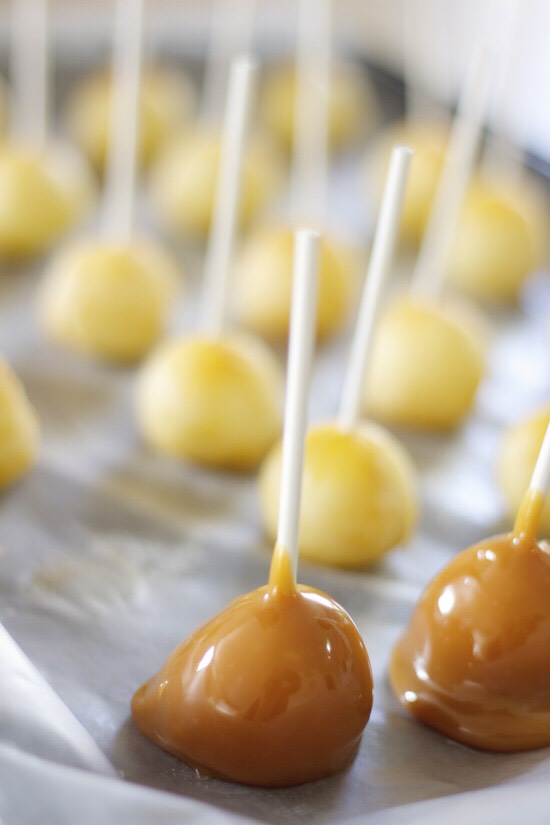 Warning: because peeled apples are a lot more slick and wet than apple skin, you might want to pat the apple pops dry with a paper towel one more time before you start dipping them, and you should put them back in the freezer right after dipping to let the caramel set. Otherwise, it will just slide 