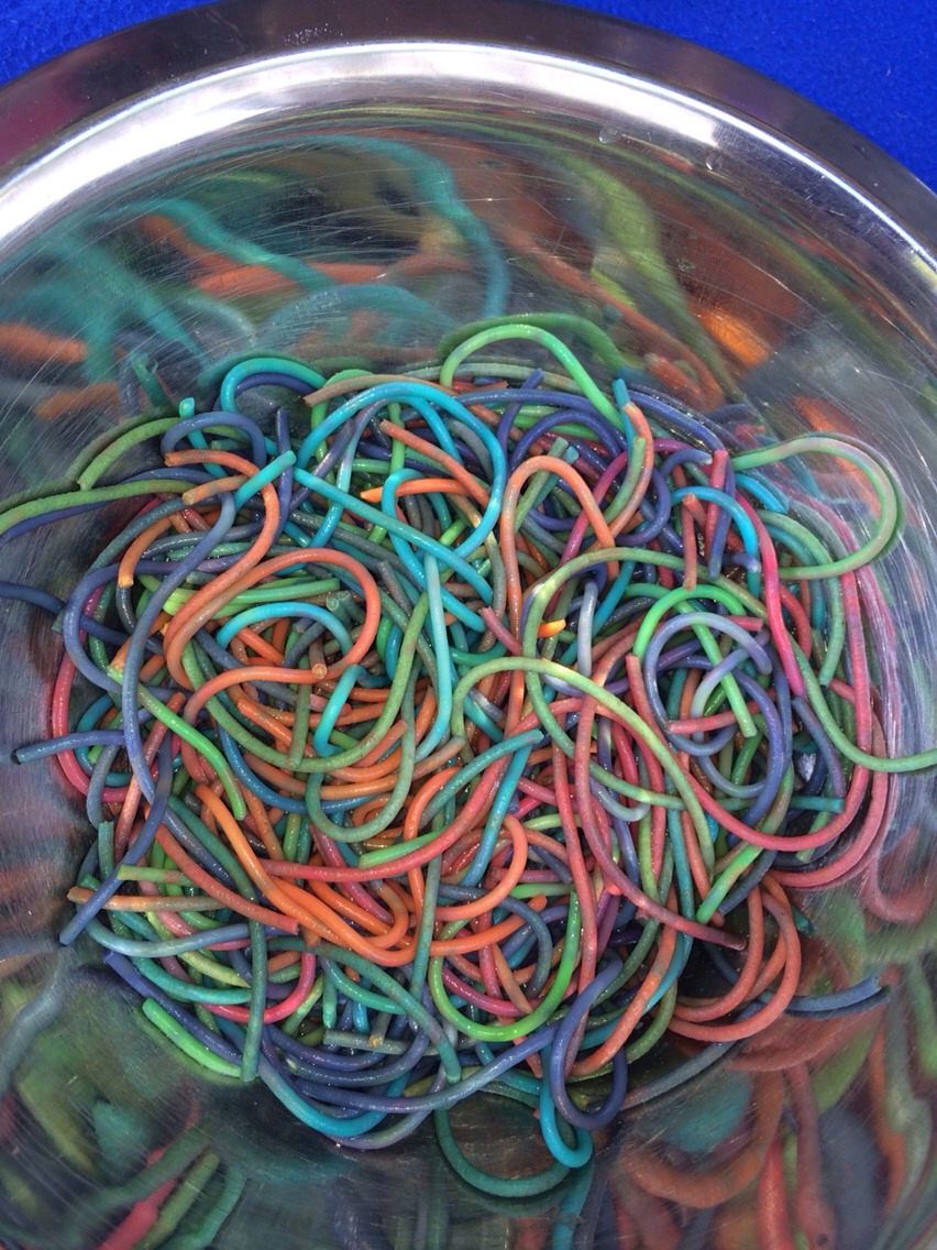 Cook noodles put 1/4 cup water in a snap lock bag add food colouring. Add pasta and let sit for a while. Rinse  off pasta then it's ready to go