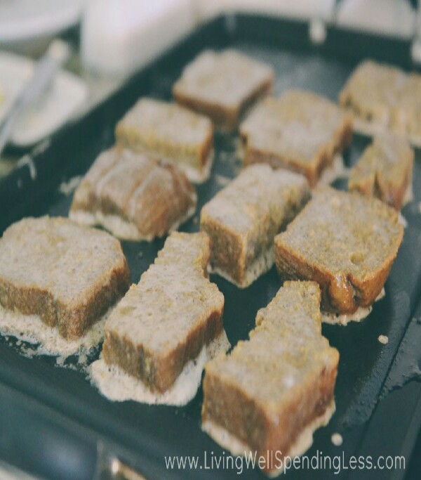 Use butter or coconut oil to grease pan.  Place coated bread slices on hot griddle and cook until golden brown, 2-3 minutes per side.  Serve with butter, powdered sugar, and real maple syrup!