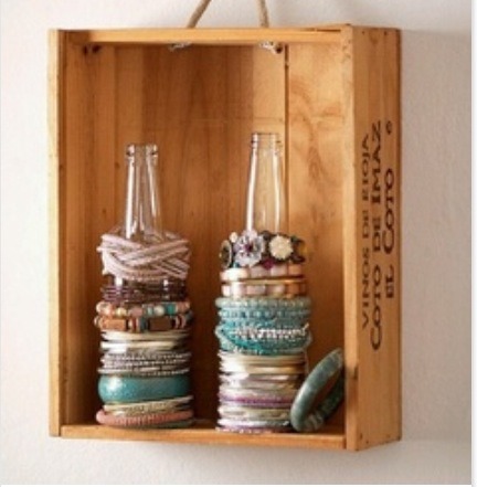 A cool wooden box with a couple of beer bottles are perfect for holding all of your bracelets while still looking artsy 