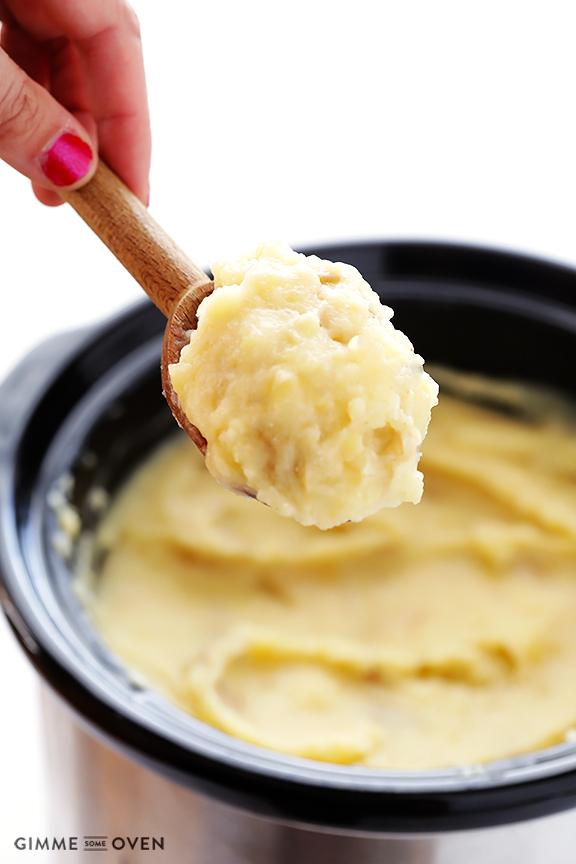 Begin by chopping up your potatoes and tossing them in the slow cooker.  I’m a big fan of using Yukon gold potatoes for the ultimate in buttery, creamy, mashed potato deliciousness.  Add some chicken or vegetable broth, about 4 tablespoons of butter (cut into small pieces), and a few cloves of mince