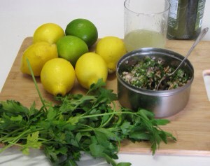 Gather up all the ingredients including a flat board to roll the grape leaves.
Rinse the grape leaves to remove as much brine as possible.