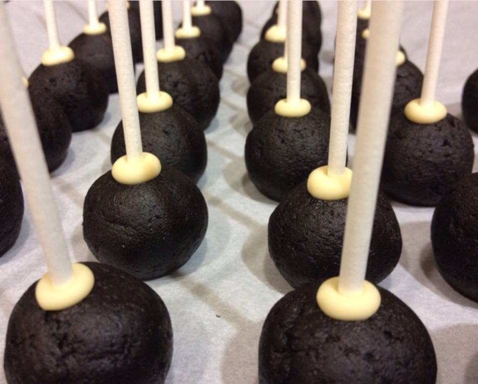 Melt chocolate and dip lolly pop sticks into the chocolate then push about half way through the balls,refrigerate for 10mins.