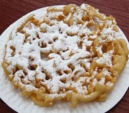 3. Using a funnel, drop into hot oil working from center outwards in a web pattern. (You can use a gallon sized freezer bag instead of a funnel by pouring the batter into the bag, snipping off a small corner of it, and squeezing the batter into the oil.)

4. Cook for about 2-3 minutes,