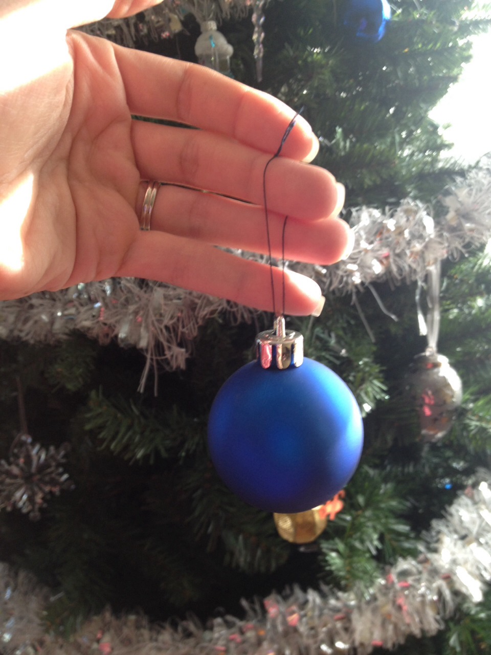Not only is this safer but it looks nicer on your tree, the ornaments hang nicer and you don't have to re-hook your ornaments every year because the thread will still be there and does not have to be removed 

Don't forget to like and share my tip PLEASE! :) 
Merry Christmas!!!