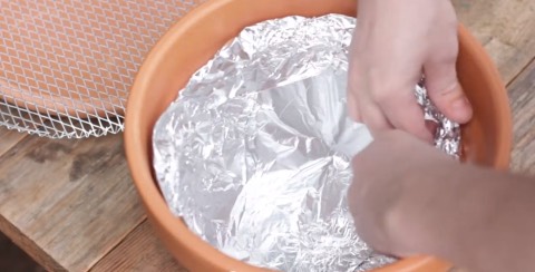 3. Line the inside of your pot with tinfoil, making sure to cover the hole at the bottom.