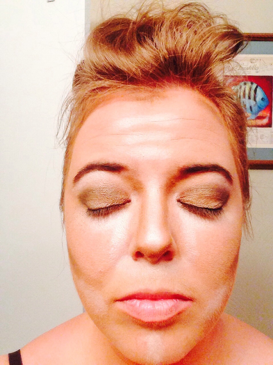 Create a smokey eye by starting with a sandy-gold color all over the lid. Blend it up into the highlight you applied to the brow bone. With a darker color make a sideways v at the outer corner of each eye blending toward the center of the eye. Line eyes with a dark liner pulling up at the corners.