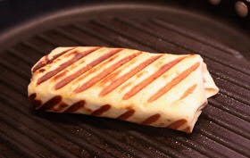 The combination of hot grill and the cooking spray make the "shell" of this wrap wonderfully crispy.  The sauce and filling is hot and best of all - the cheese is gooey!  (Oh I DO have a love affair with gooey cheese!  Sure is a good thing I used the low fat kind!)
