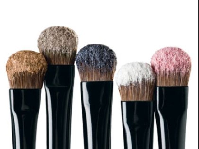 Gently rub your brushes of the hair donut and the make up will come off. 