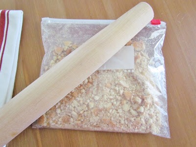 If you haven't done so already, crush your vanilla wafers.
I just place mine in a ziploc bag and crush them with a rolling pin.
Leave some of the pieces big. It's nice to have a bit of a crunch when you eat the cake.
