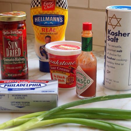 ¼ cup sun-dried tomatoes in oil, drained and chopped
8 ounces cream cheese, room temperature (so there’s no lumps)
½ cup sour cream
½ cup good mayonnaise (such as Hellman’s Real)
10 dashes Tabasco sauce
1 teaspoon kosher salt
¾ teaspoon freshly ground black pepper
2 scallions, thinly sliced