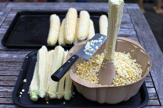 17. Cut corn off the cob quickly and neatly by holding it steady with a bundt pan. Get out a sharp knife and a large bundt cake pan, and get cutting. The center of the pan will help you hold the cob securely in place and the pan will catch all the corn while you cut.