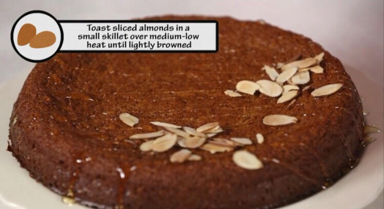 To serve, drizzle the top of the cake with honey and sprinkle with sliced almonds.
Make Ahead Tip: Store the cooled cake airtight at room temperature for up to 1 day. Drizzle with honey and sprinkle with almonds just before serving.
Equipment: 9-inch springform pan, parchment paper.
