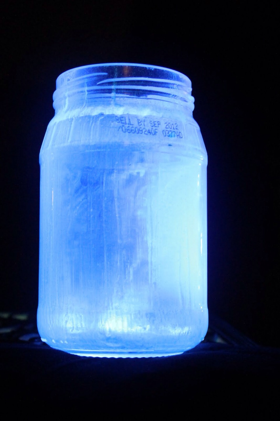 Snap and shake a glow stick and empty enough to evenly cover the jar you will need to shake the jar, this is great for party's!