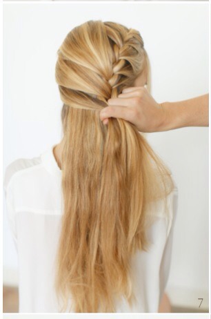 7) Once you have placed all the loose hair into the braid, continue braiding the tail and secure with a clear rubber band.

