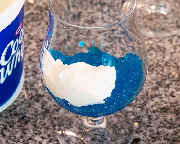 Add part jello & cool whip into glass to make the cool cloud design.