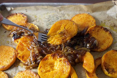 Pile onions on top of roasted squash, still on their baking sheet. Use a fork to gently half-mash the mixture; I like this best when the mixture is not uniformly combined. Taste and adjust seasonings if needed.