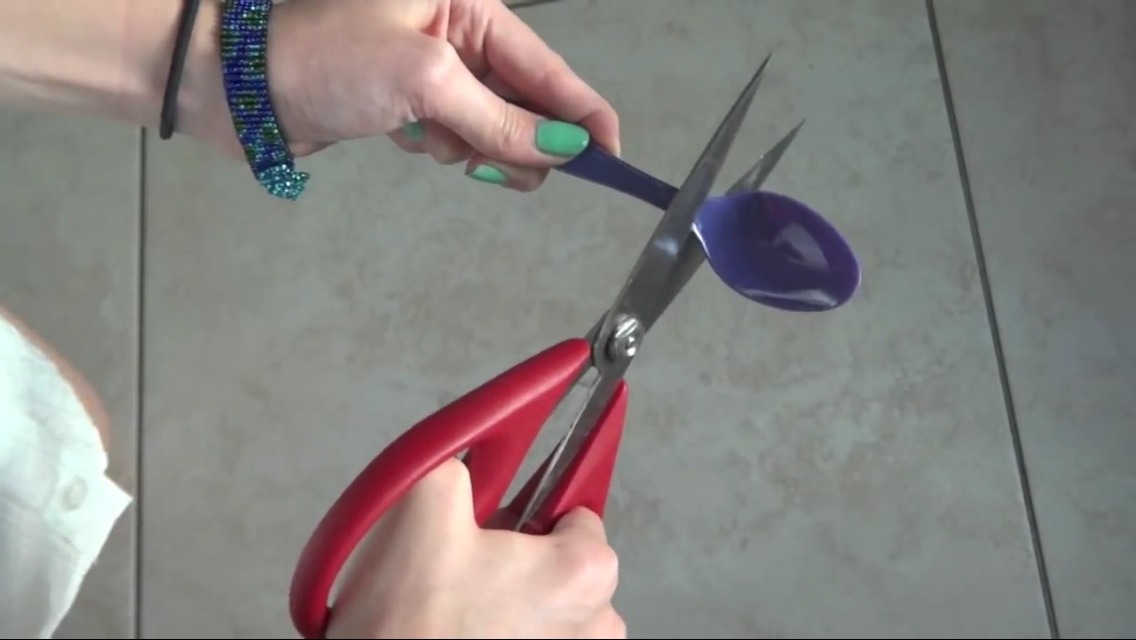 First you'll want to start by cutting the ends of the spoons off.