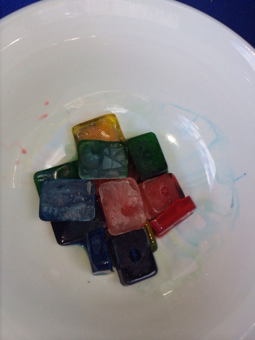 Place water and food dye in ice cube tray and freeze (this will stain so wear old clothes )
