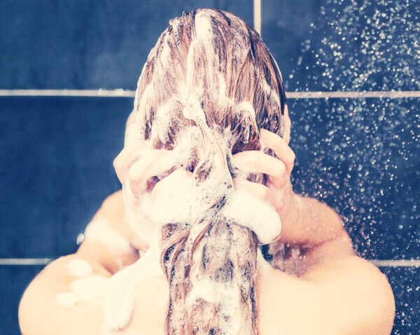 When you have a shower wash your hair first.
The oils from the shampoo and conditioner can cause acne, break outs and oily skin if left unwashed.