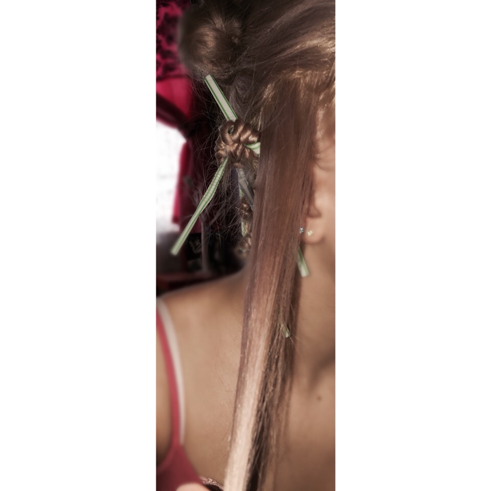 What you want to do first is spray a section of your hair with water.