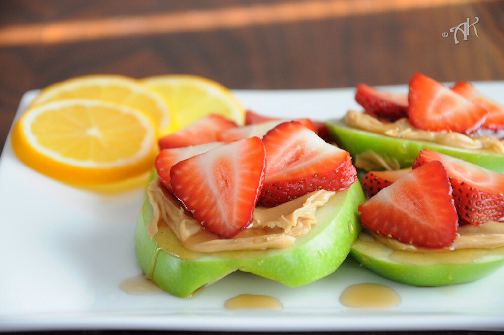 Strawberry apple sandwiches! This is so easy, delicious and surprisingly filling. Simply slice the apple into donut shapes, spread peanut butter all over and top with strawberry's :)