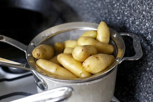 Meanwhile, cook potatoes: In a separate saucepan, cover potatoes with 1 to 2 inches cold water. Set timer for 15 minutes, then bring potatoes to a simmer. When the timer rings, they should be easily pierced with a toothpick or knife. Drain and keep warm.