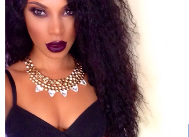 13. Neutral eyes, bold brows, deep plum lip. 