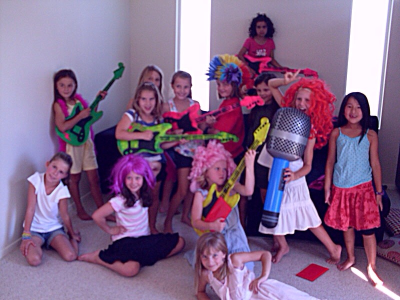 Make your own photo room / booth.
Add loads of props. You can get these from the pound shop.
Things like blow up gaiter
Sunglasses.
Beaded necklaces.
Wigs.
Anything you can think of.
Then click click click. Youl catch some great shots. Ideal if some kids are shy