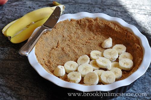 Now its time to bring it all together. Cut up bananas into slices and lay into your crust. It doesn't matter how you arrange them really. Just go wild. 