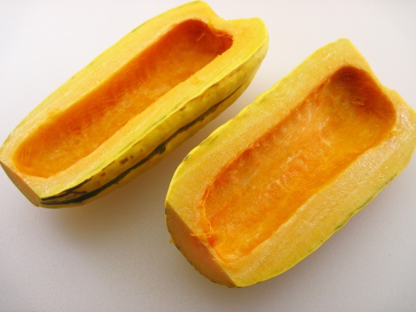 2. Cut the squash in half and remove the seeds.

3. Slice the squash halves into ½-inch slices.