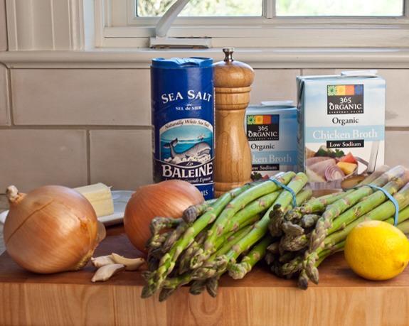 2 bunches asparagus (about 2 pounds)
3 tablespoons unsalted butter
2 medium yellow onions, chopped
3 cloves garlic, peeled and smashed
6 cups low sodium chicken broth
Salt
Freshly ground black pepper
2 tablespoons freshly squeezed lemon juice, from one lemon
1/4 cup grated Parmigiano-Reggiano
Herbs