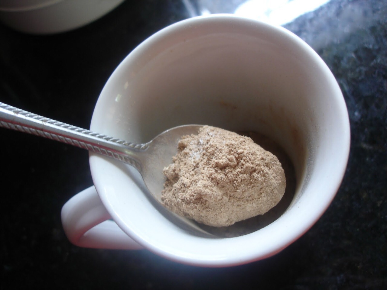 Step one:
Spray a mug or ramekin with cooking spray. In the cup combine the flour, sweetener, cocoa powder, baking powder, and salt until no lumps remain. Stir in the milk, olive oil, and vanilla until smooth.