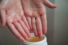 Scoop out a handful of organic virgin coconut oil. My hair is very thick and long so my scoop has to be extra big. The oil will begin to melt at the touch of your skin, there is no need to heat the oil before application. It will melt as you massage it into your hair.

