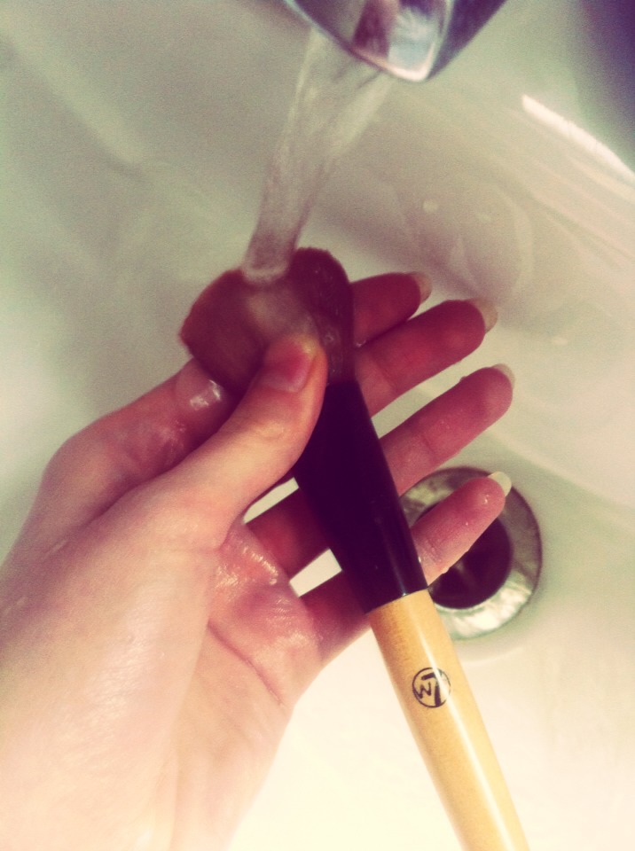Rinse your lathered brush under the tap to get rid of the soap suds.