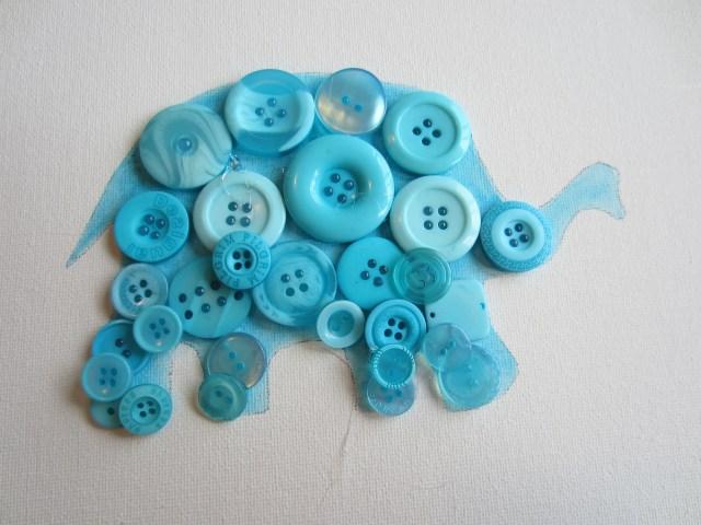 Now for the buttons!
Get out your trusty glue gun and add the first layer like so, trying to cover as much space as possible without going over the edges.