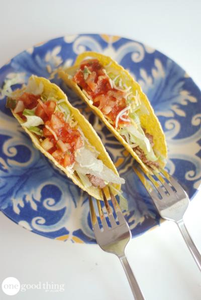 Use a fork to keep taco shells steady while filling them up.